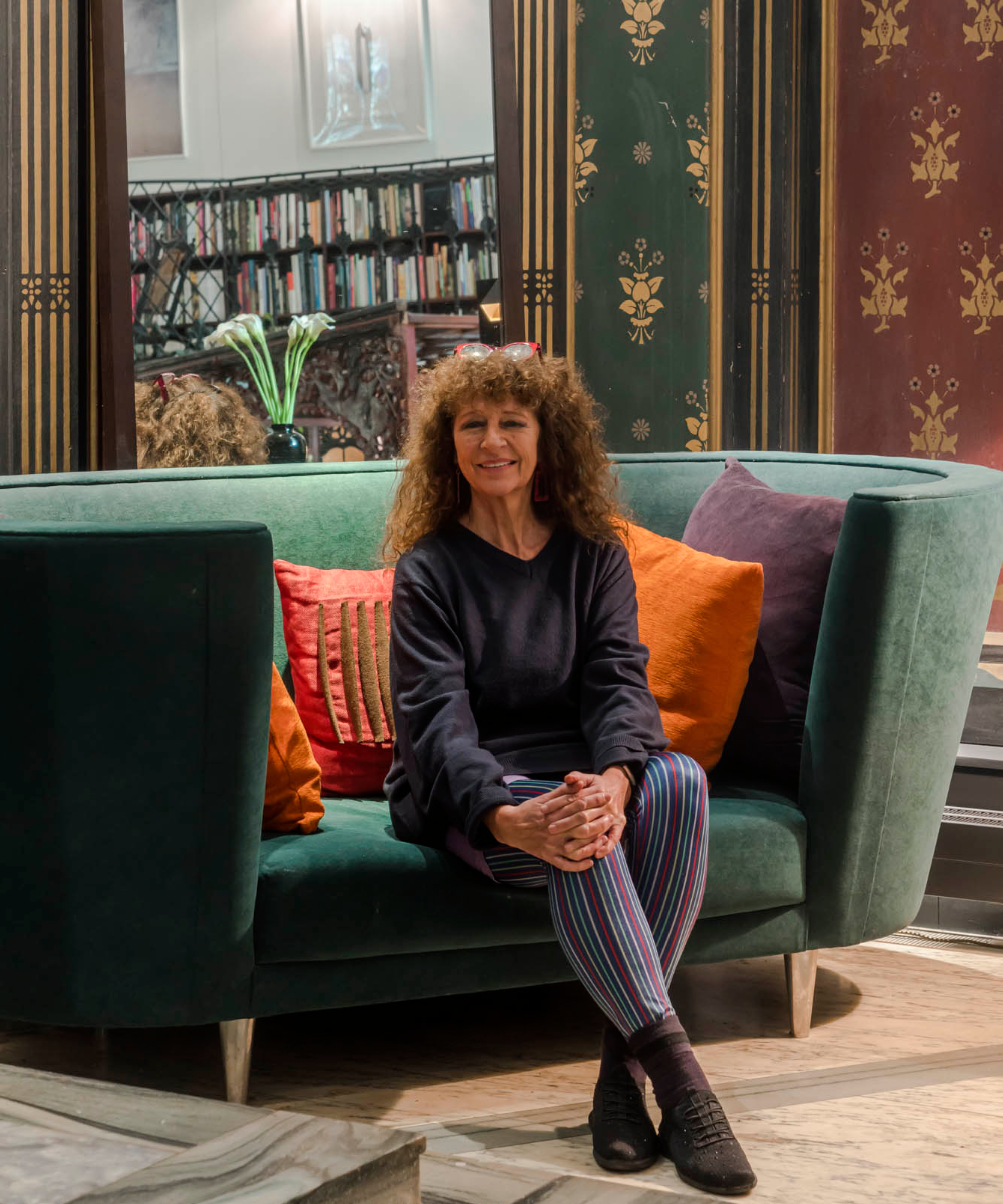 woman sat on green sofa in chapel conversion