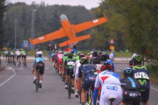 The peloton rides toward the memorial to aircraft engineer Ermanno Bazzocchi in Tradate