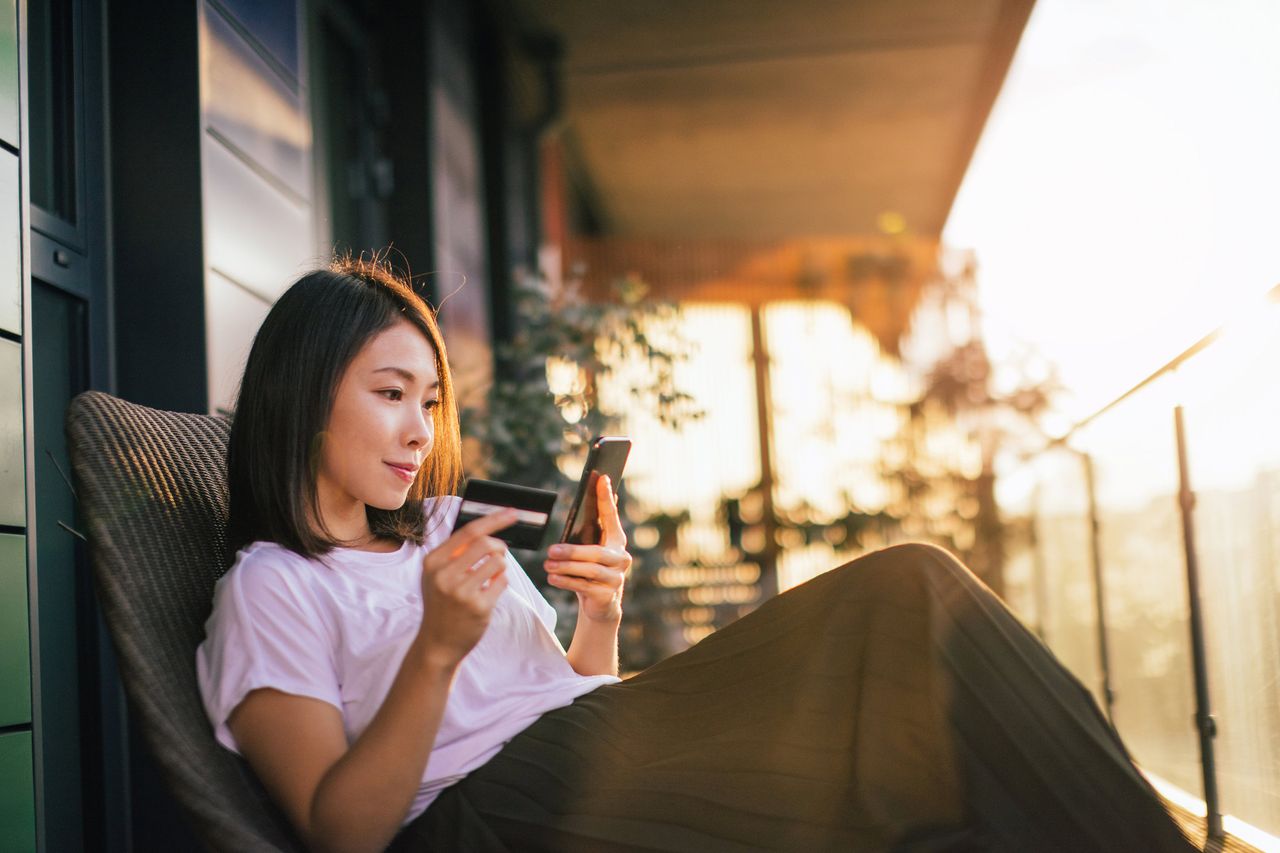 photo illustration of woman holding credit/debit card