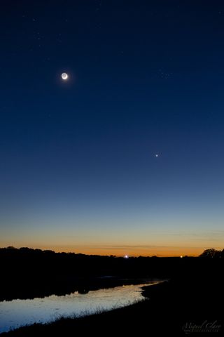 The crescent moon, the Pleiades star cluster and the planet Venus form a triangle above the Dark Sky Alqueva Reserve in Portugal.