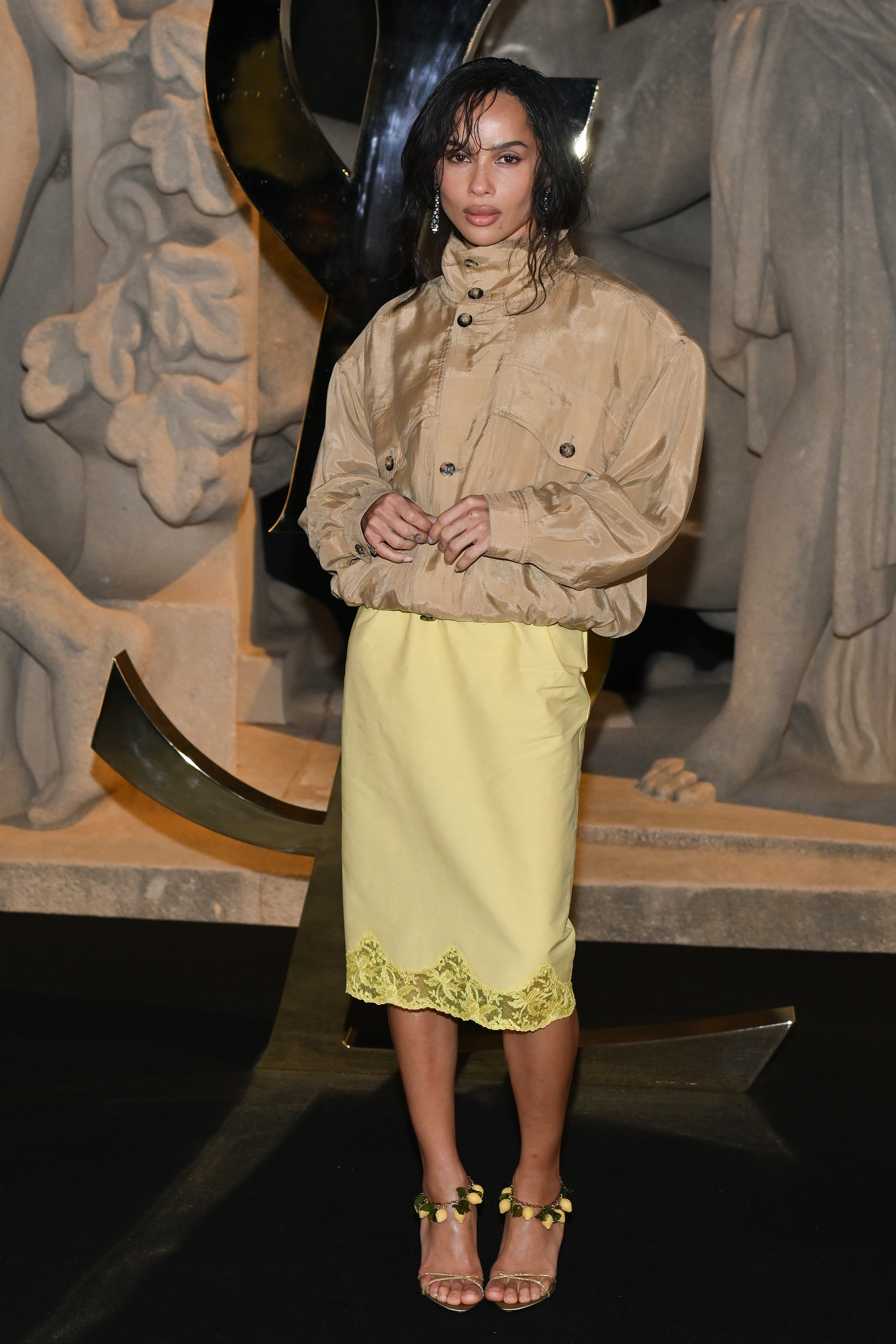 Saint Laurent guests wear pencil skirts and voluminous tops.