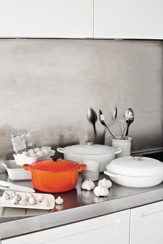 Le Creuset casserole pots on kitchen counter