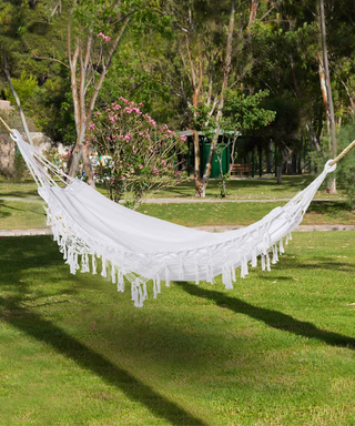 white boho hammock in a garden