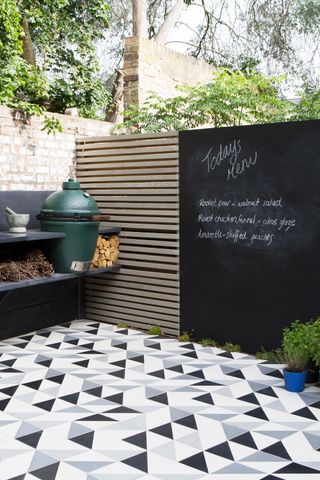 small garden ideas with patterned tile floor and outdoor kitchen