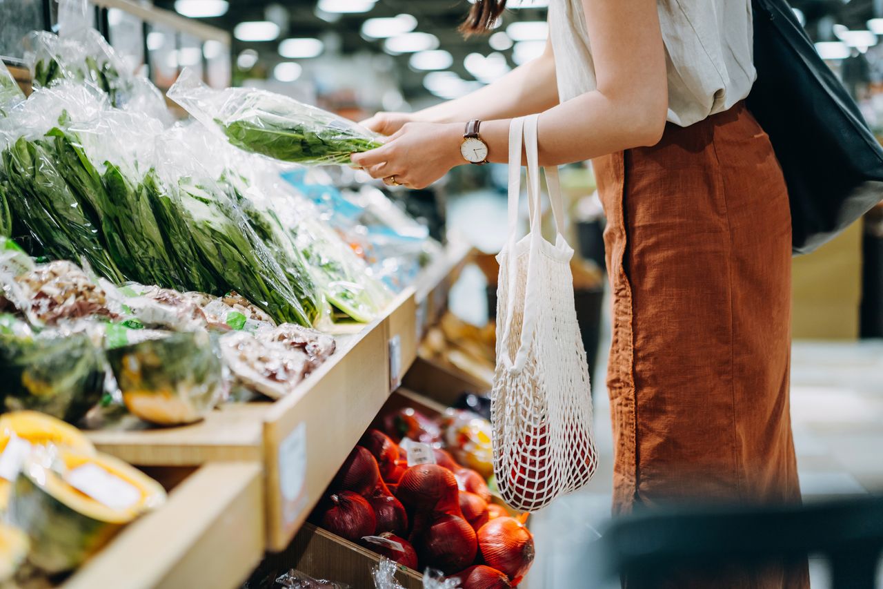 Woman shopping for fresh organic groceries in supermarket.