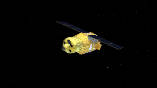 A rendering of a space probe hangs in a black, starry sky. it is mostly cylindrical and warpped in gold foil. Camera lenses point from the closer end, and three-paneled solar panels are unfurled across the back of the wider, rear cylindrical part of the body. 