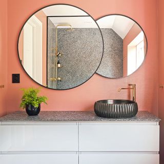 bathroom peach color wall with round wash basin