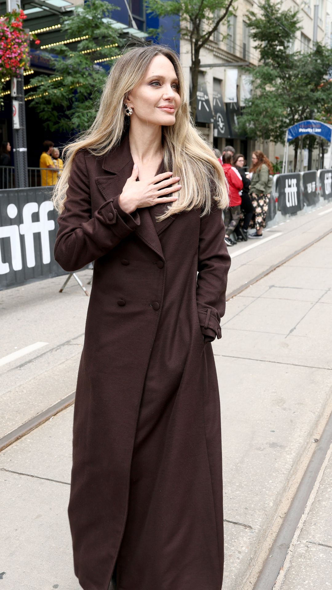 angelina jolie wearing a brown trench coat
