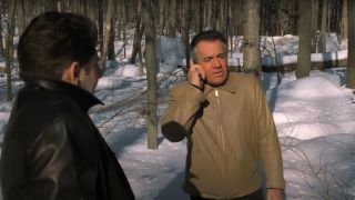 Michael Imperioli watches Tony Sirico take a phone call in the woods in The Sopranos.