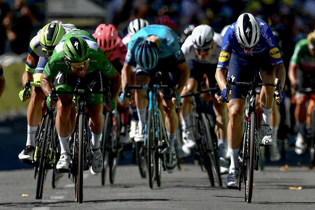 Stage winner Team Deceuninck Quicksteps Mark Cavendish of Great Britain wearing the best sprinters green jersey crosses the finish line at the end of the 13th stage of the 108th edition of the Tour de France cycling race 219 km between Nimes and Carcassonne on July 9 2021 Photo by Philippe LOPEZ AFP Photo by PHILIPPE LOPEZAFP via Getty Images