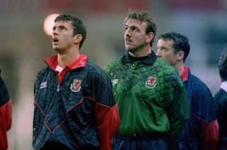 Gary Speed and Neville Southall stand for the Welsh national anthem.