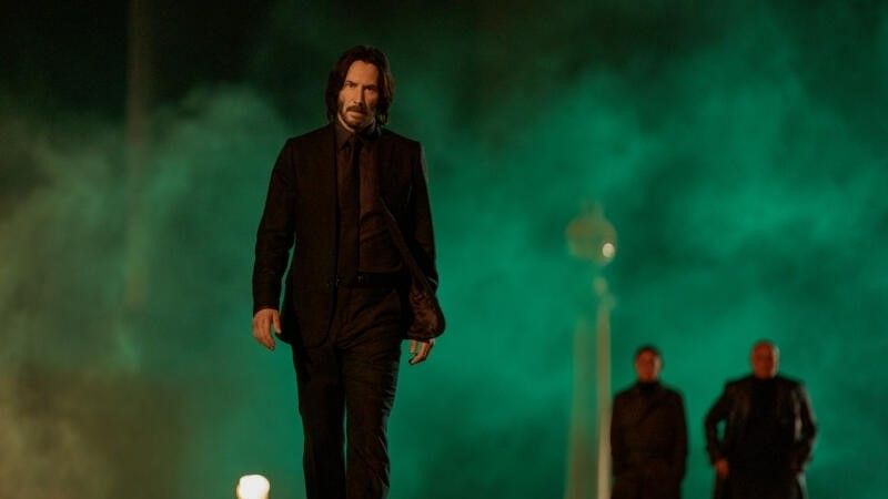 Keanu Reeves walks with men behind him in John Wick: Chapter 4
