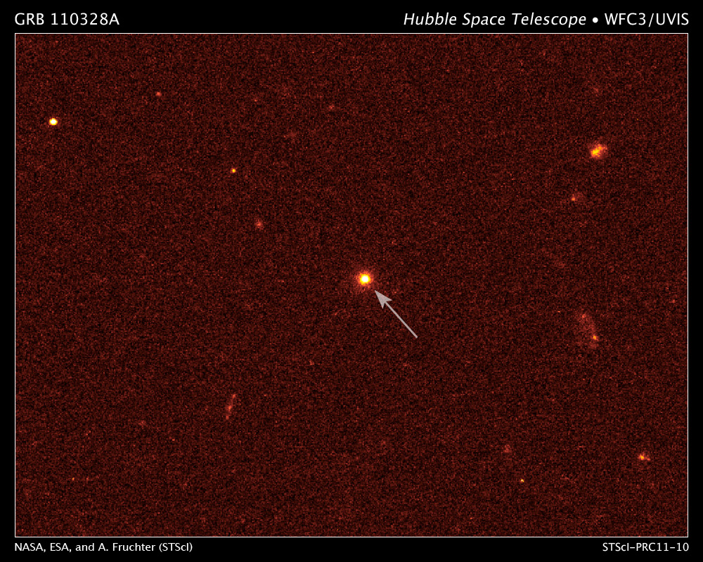 This is a visible-light image of GRB 110328A's host galaxy (arrow) taken on April 4 by the Hubble Space Telescope's Wide Field Camera 3. The galaxy is 3.8 billion light-years away.