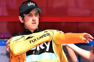 Geraint Thomas pulling on the leader's jersey