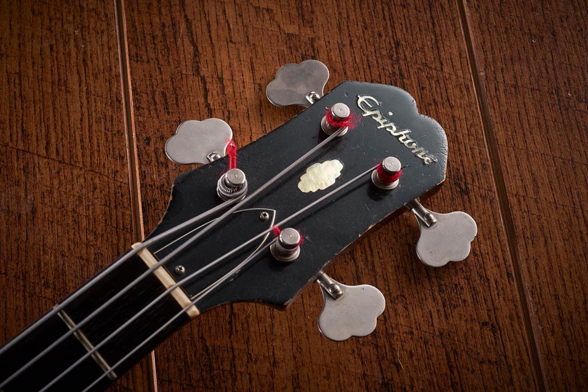 Aside from the Epiphone epsilon logo on the pickguard, the Rivoli can immediately be distinguished from the EB-2 by its headstock shape and inlays