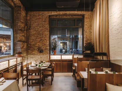 Interior of Restaurant Normal by Roca Brothers, with exposed brick walls and wooden furniture