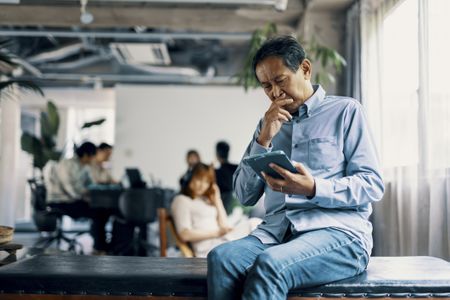 Older man looking at a tablet 