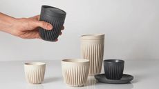 Huskee coffee cups in different sizes, in black and cream