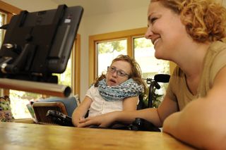 Eyetracker technology helps this girl interact with friends and caregivers.