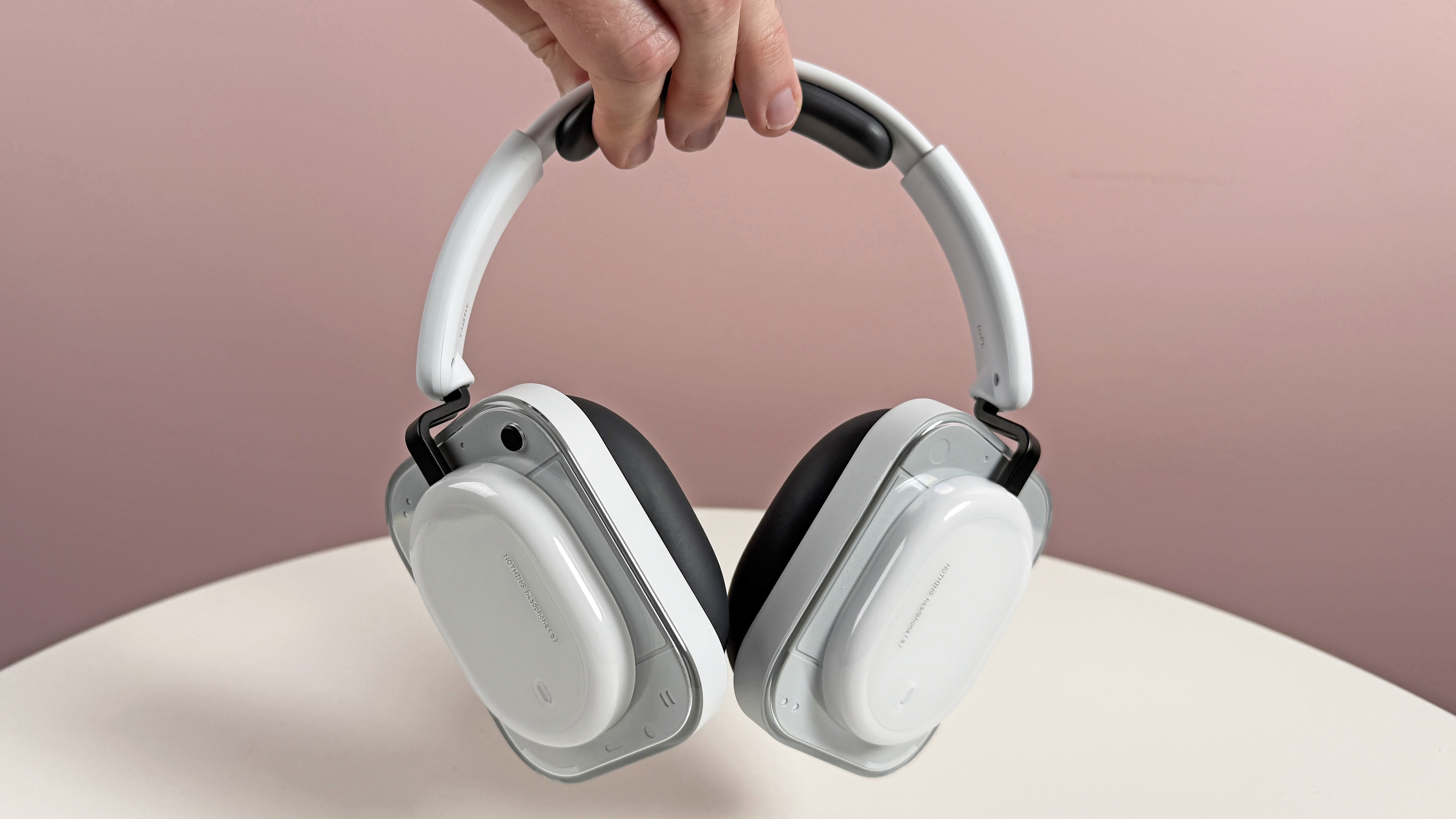 The Nothing Headphone (a) held in a man's hand