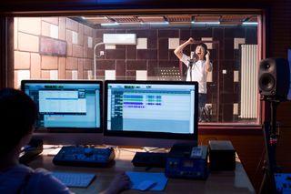 Man recording vocals in a recording studio