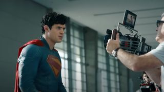 A man in a superhero costume on a movie set