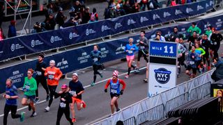 Participants run through Times Square during the United Airlines NYC Half on March 17, 2019
