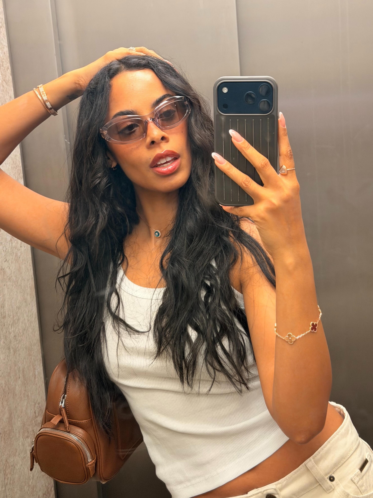 Rochelle Humes with long wavy hair, taking a photo in a mirror