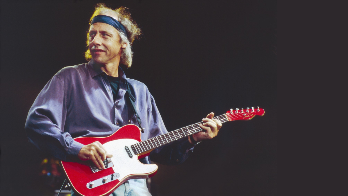 Mark Knopfler of Dire Straits performs on stage in Birmingham, 1991. He is playing a Schecter guitar.