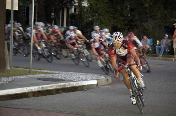 Fly V Australia leads the peloton through a turn.