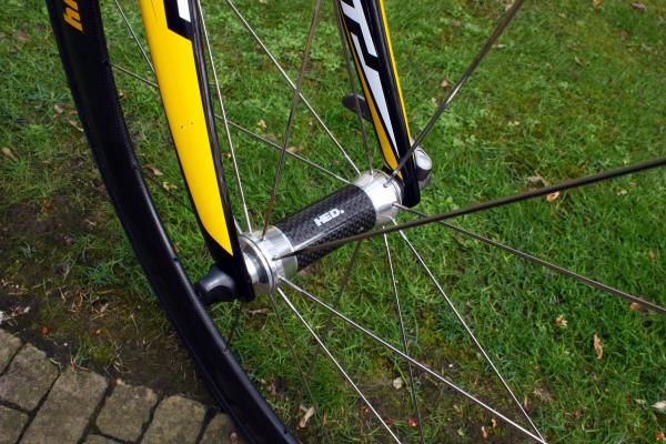 HED's 'Flamme Rouge'-edition front hubs feature a carbon fiber center section to shave a few grams.