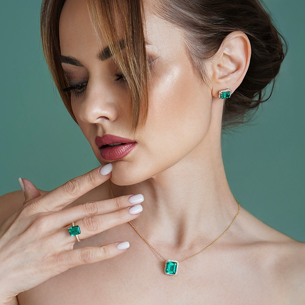 Model wearing emerald gemstone jewellery sold at Angara