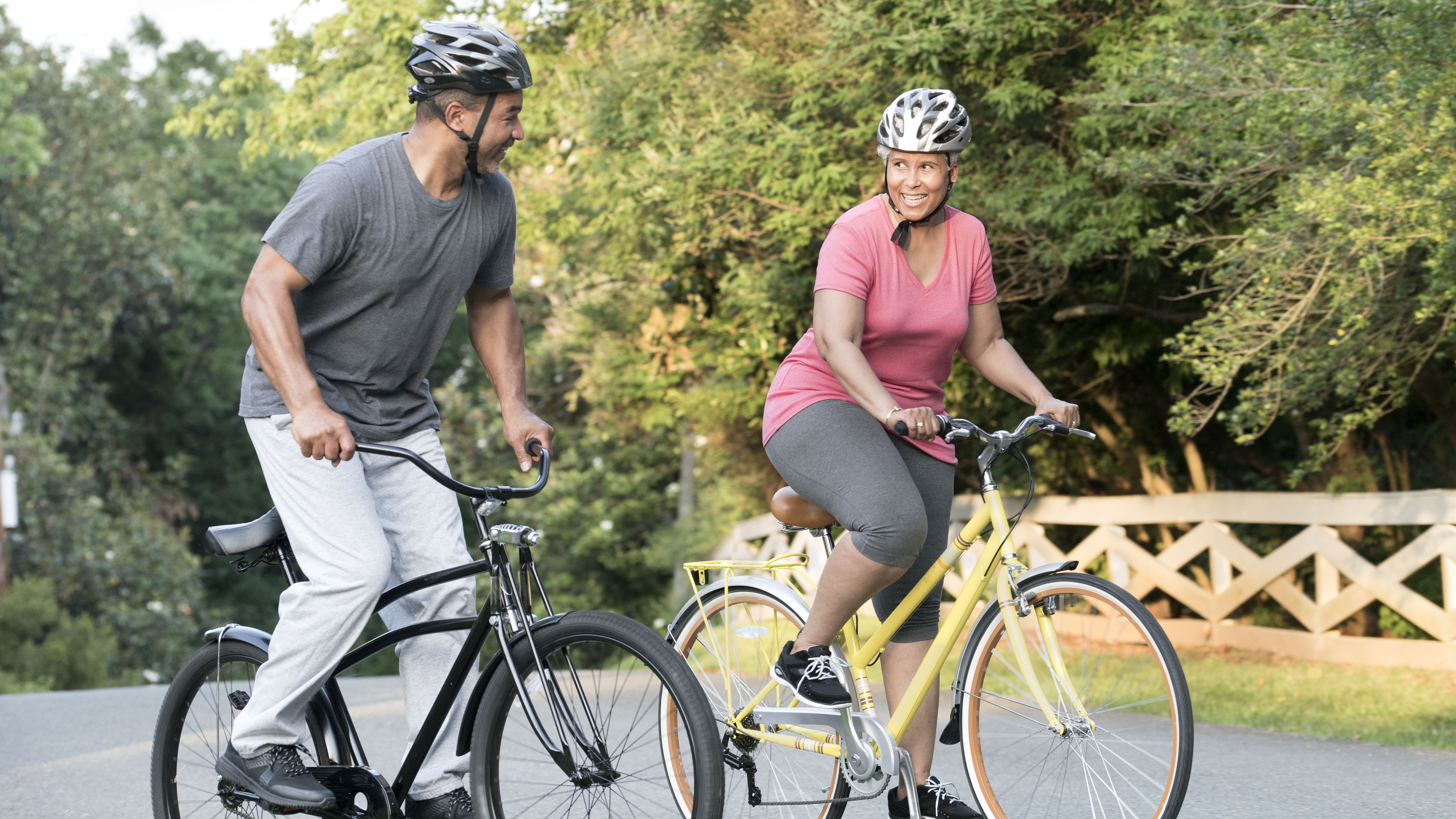 Couple exercising on bikes outdoors