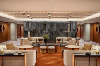 The lobby boasts wooden walls and cream sofas