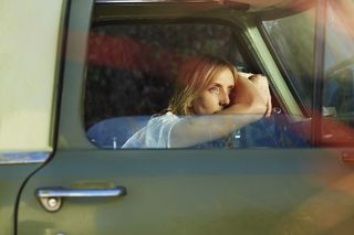 A girl lying on the car