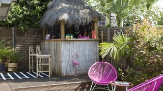 Outdoor tiki bar with colour pop seating