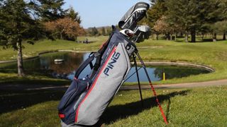 Ping hoofer lite stand bag resting on the golf course