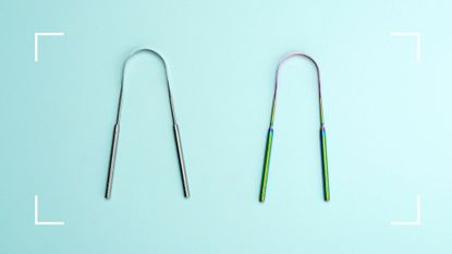 Two metal tongue scrapers on light blue background to illustrate the benefits of scraping your tongue