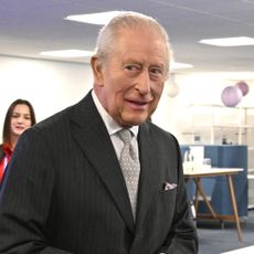 King Charles makes an error and drops a plaque and looks embarrassed