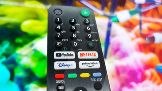 A remote control featuring streaming service buttons including Netflix, Amazon Prime and Disney Plus