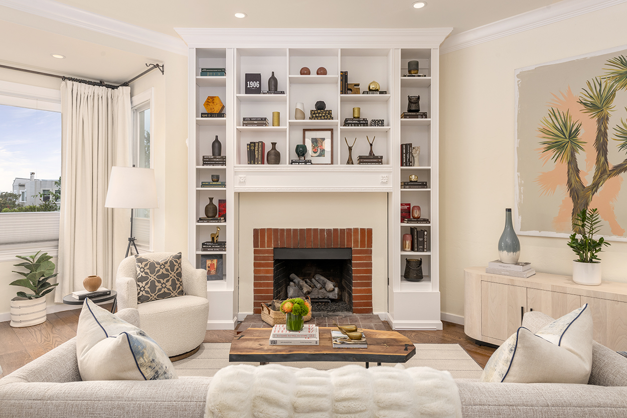 A fireplace surrounded by bookshelves