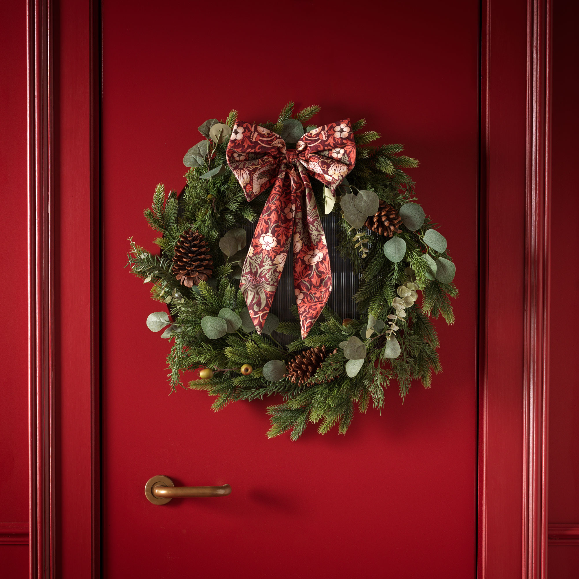 Red door with wreath with red bow