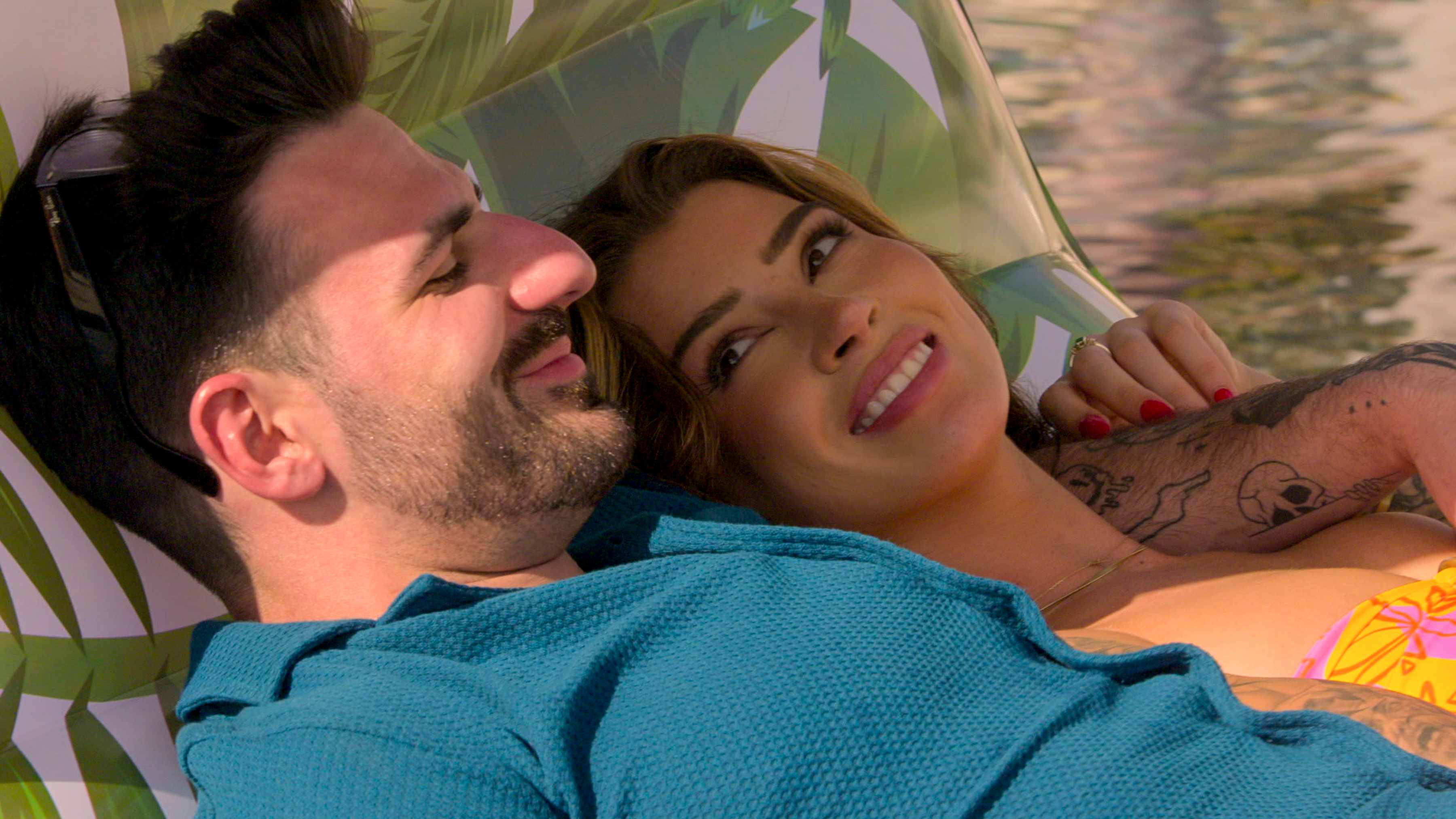 ali and anton from love is blind season 9 laying on a hamock while on vacation