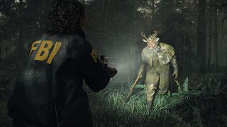 Alan Wake 2; a person shines a torch on a creature in a forest