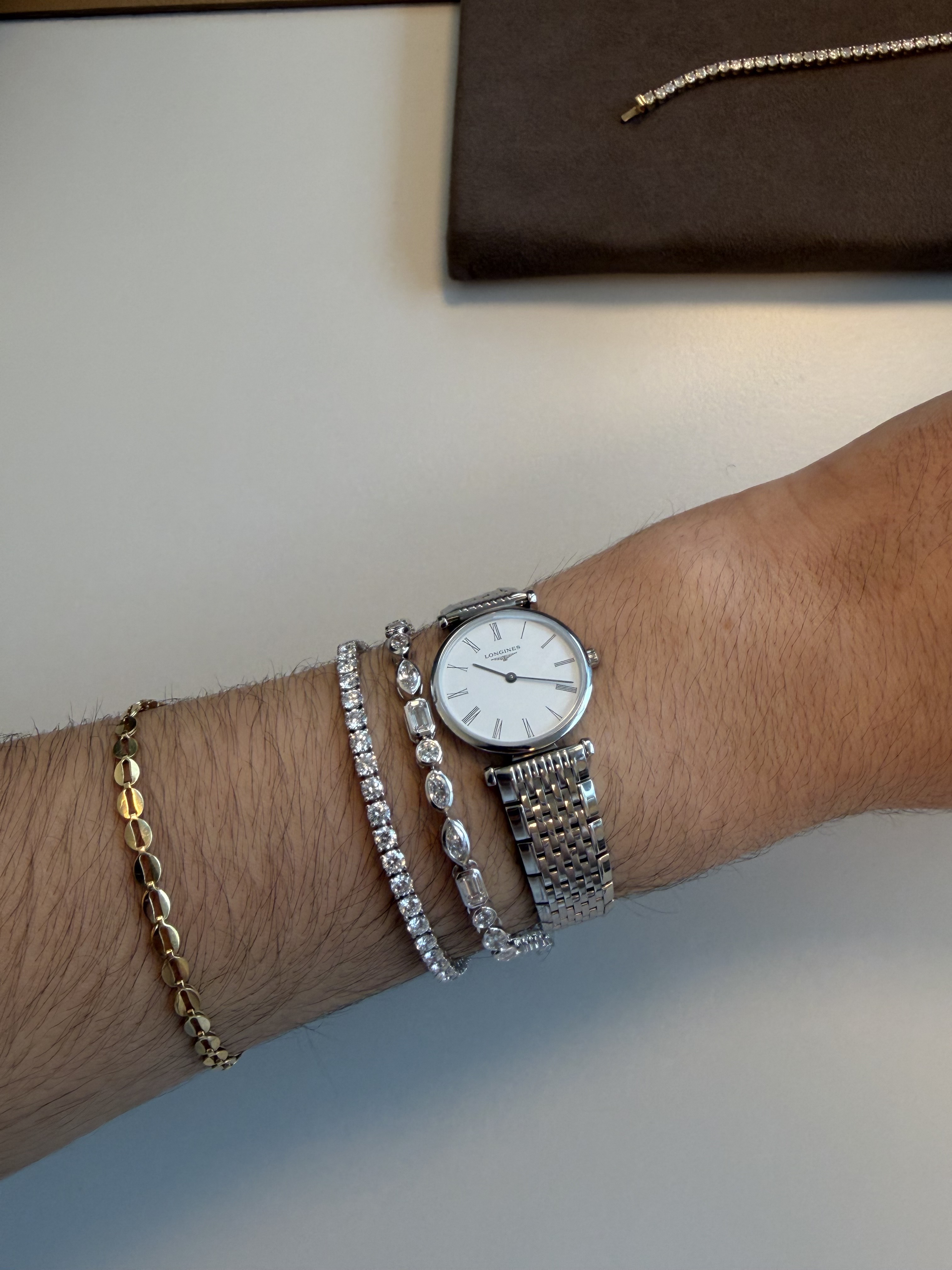 Who What Wear editor wears diamond tennis bracelets.