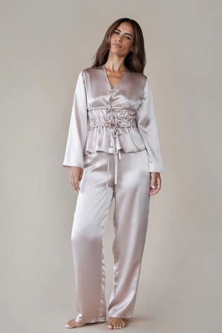 woman wearing pink silk pj set with ruched detail on the top