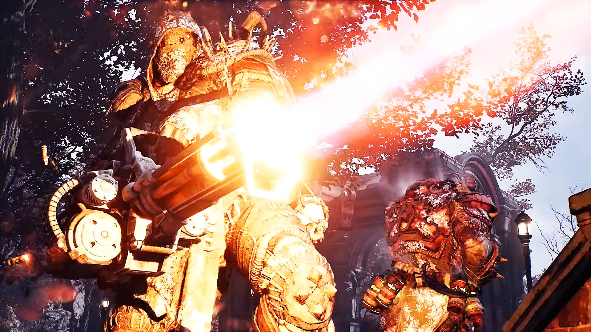Two armored soldiers march through a city as one armed with a mini-gun fires it into the distance.