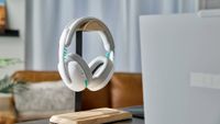 Image of the white Logitech G325 Lightspeed wireless gaming headset sitting at a desk.