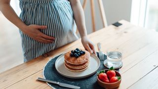 Pregnancy cravings of pregnant person eating