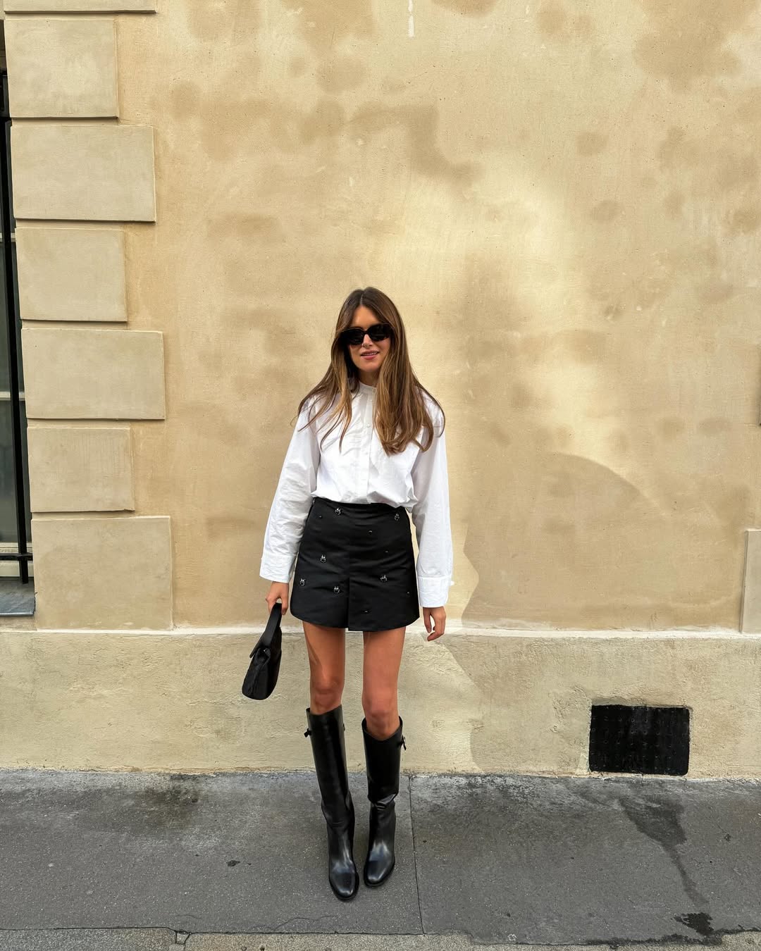 Sara in a white blouse and skirt